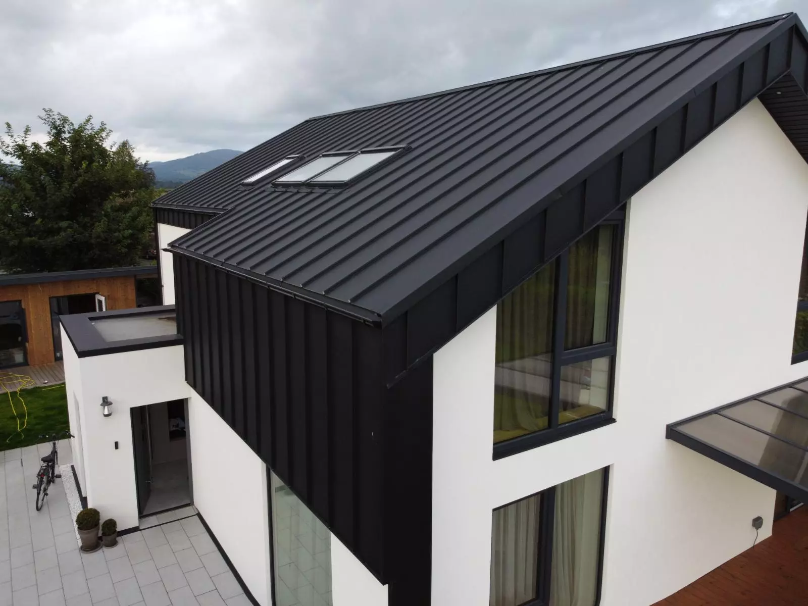Black standing seam roof on a contemporary Irish home