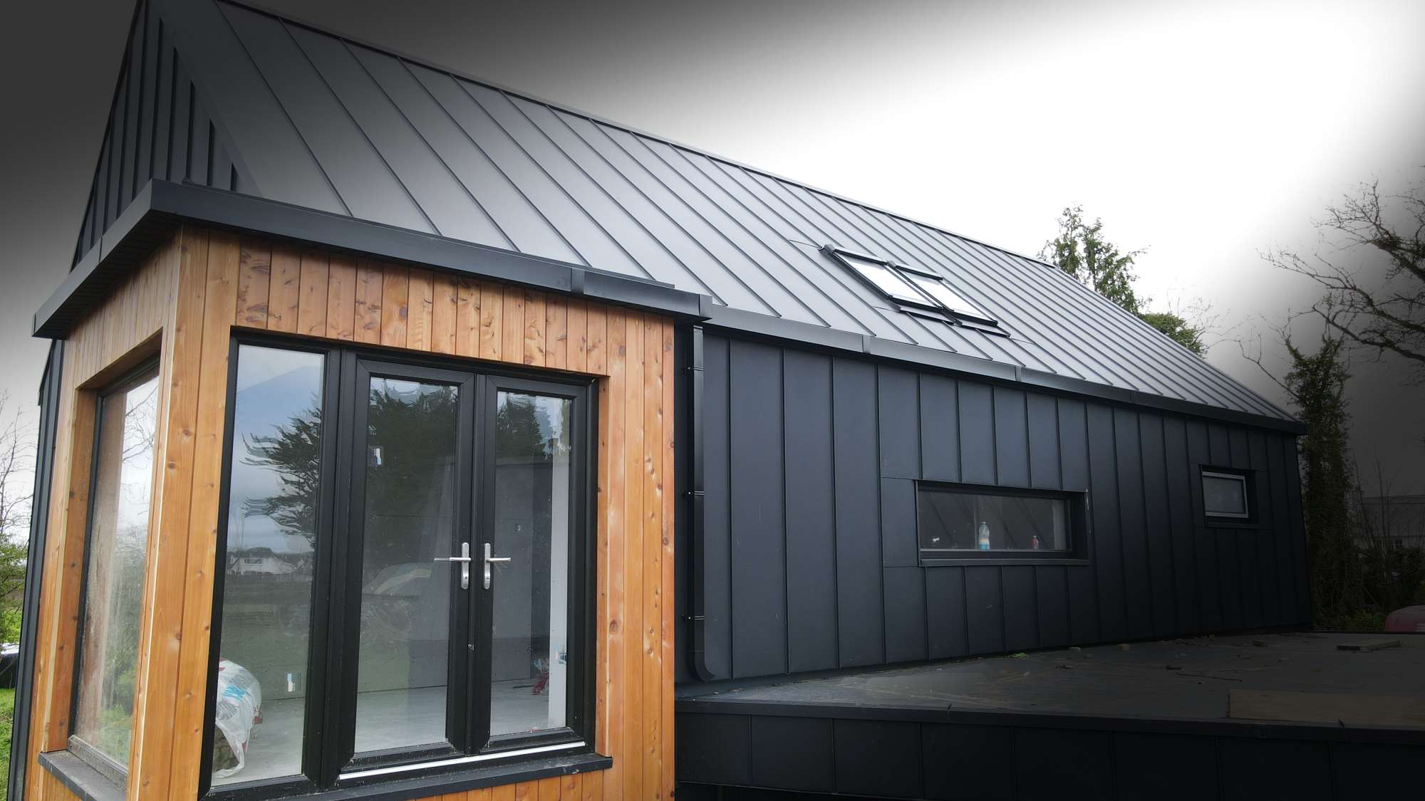 Anthracite standing seam roof and cladding with natural timber detailing